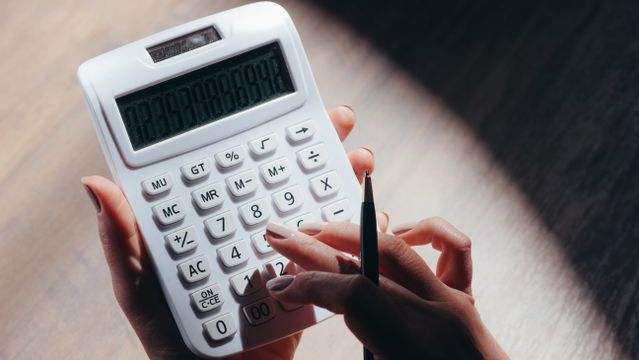 person using a white calculator